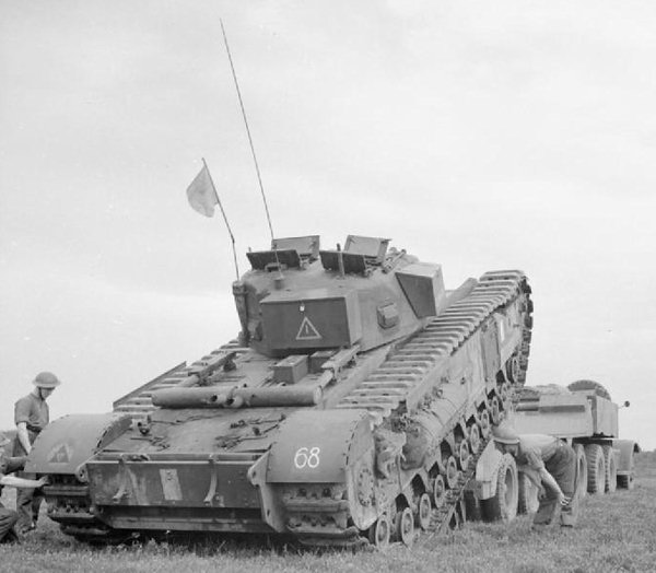 Churchil tank being loaded onto a tank transporter belonging to the 144th Regiment Royal Armoured Corps