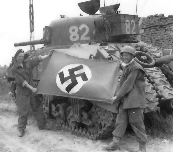 Sherman tank belonging to the 144th Regiment RAC. Notice the tank tracks welded to the front